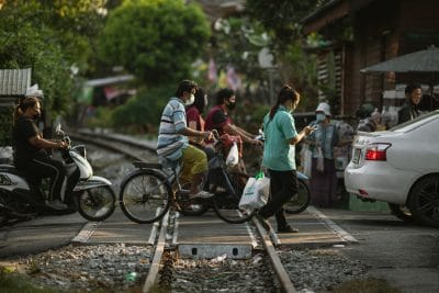 Commuters cross train tracks on foot